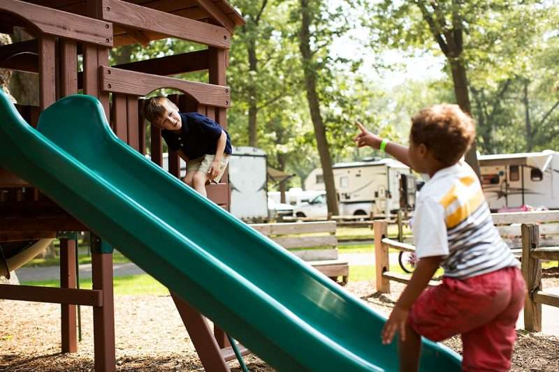 toddlers camping, playing at RV playground