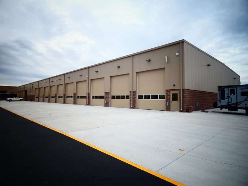 An exterior photo of the General RV Ashland Supercenter shows the long row of RV service bay doors.