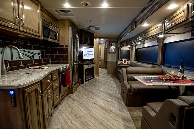 A photo from the front of the Fleetwood Bounder 35K motorhome shows the large living and dining area in the open layout. 