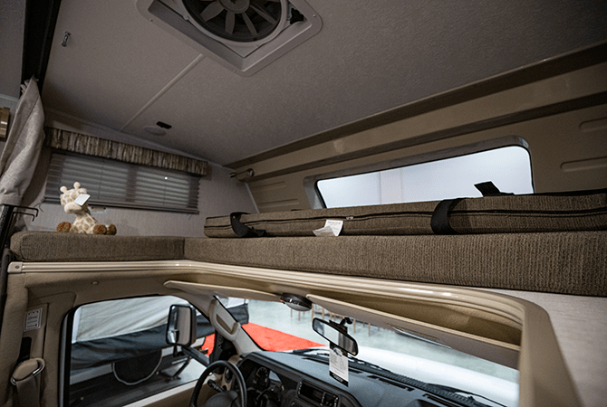 A photo of the cab over bed located at the front of the Leprechaun 319M Class C motorhome.