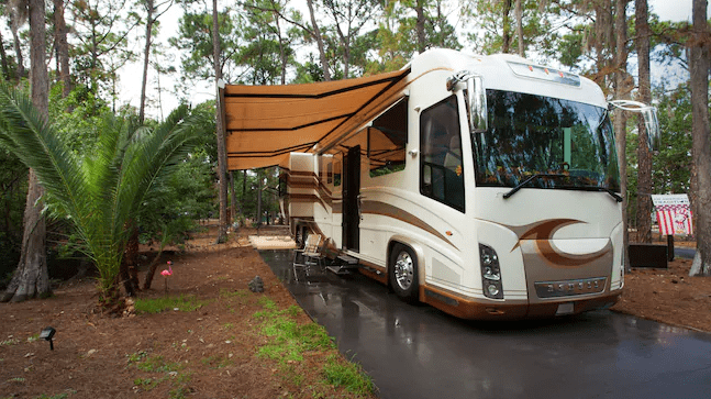 A Class A motorhome RV on a campsite at Disney's Fort Wilderness Resort and Campground in Florida. 