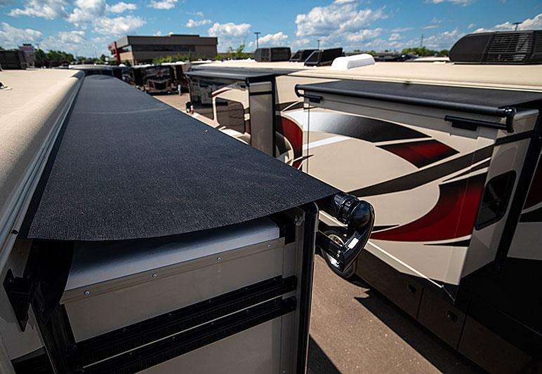 Slide toppers are installed over a slide out room on a Class A motorhome.
