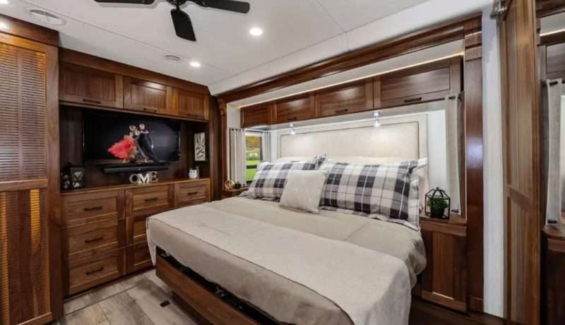 The master bedroom of the Winnebago Journey is filled with storage space - over head cabinets, dresser drawers, and a closet. There's even more storage hidden under the king size bed.