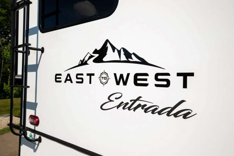East to West and Entrada logos on a white motorhome.