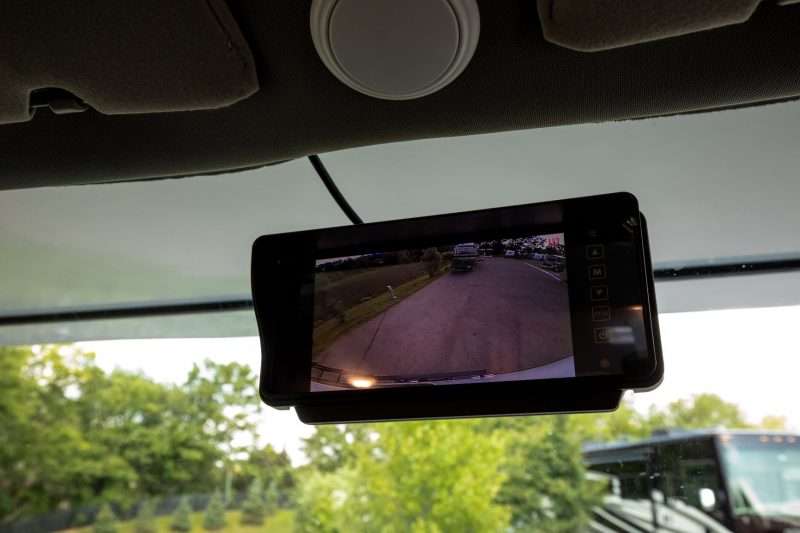 The rearview mirror of the Entrada Class C motorhome has an integrated monitor to view the backup camera.