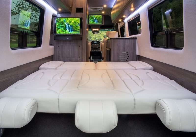 The rear lounge/sleeping area of the Strada has a cream colored Ultraleather memory foam power sofa bed that lays completely flat so you can stretch out and sleep comfortably. 