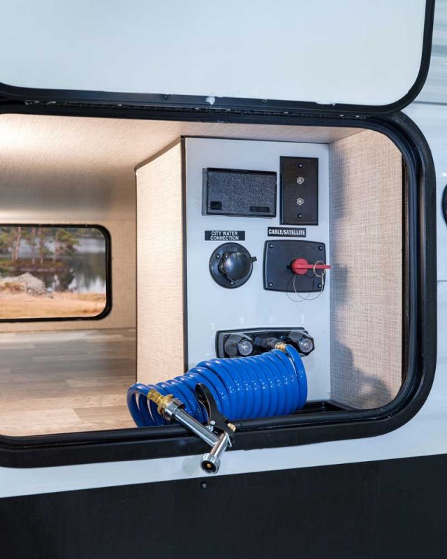 The universal docking station is located in the underside of the Della Terra. The RV's pass-through storage is fully finished with laminated flooring and finished walls.