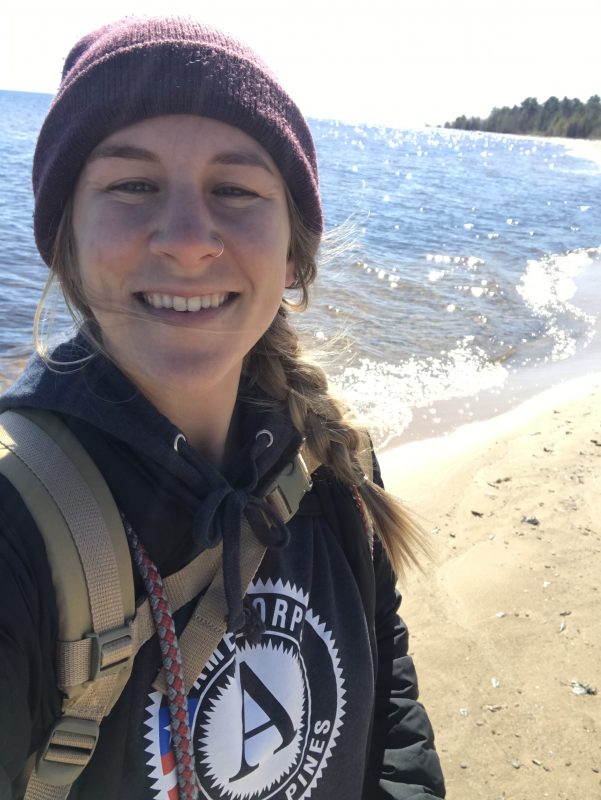 A selfie of Paige, the explorer behind Project Rustic, as she walks along a Michigan beach.