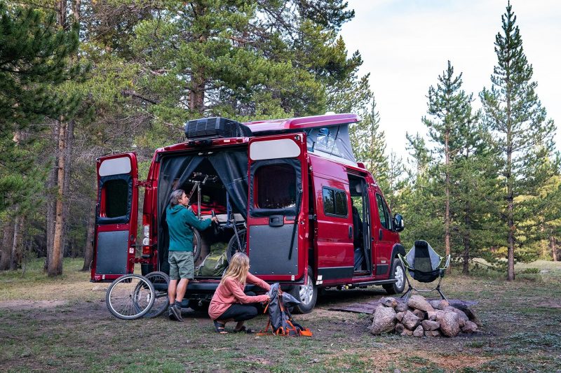 Couple prepares campsite by unloading gear from Winnebago Solis Pocket