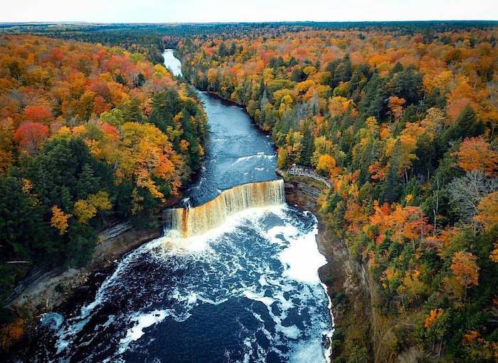 A aerial shot overlooking Tahquamenon falls and beautiful fall colors in Michigan.