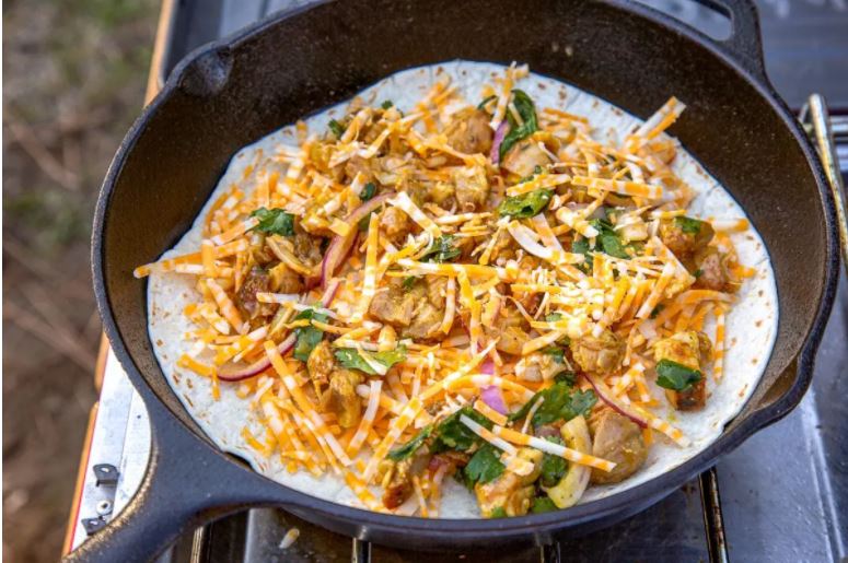 BBQ Chicken Quesadillas being cooked in a cask iron skillet.