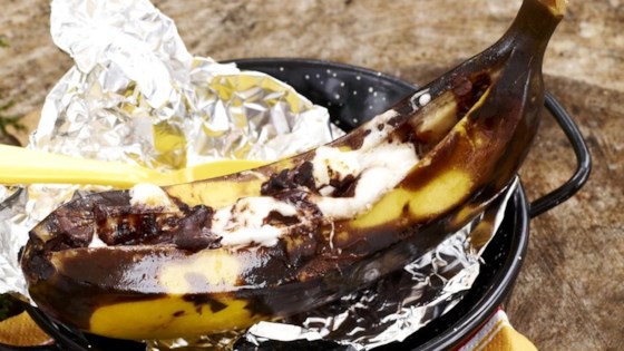 A cooked Campfire Banana Split with melted chocolate and marshmallows.