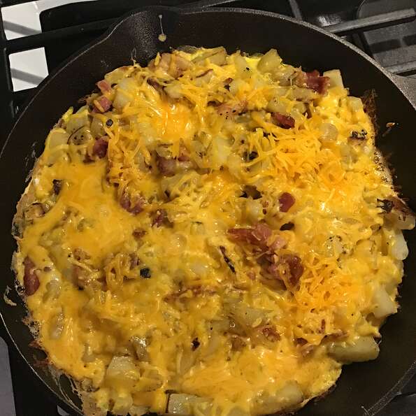 The Campfire Breakfast Skillet being cooked over a griddle.