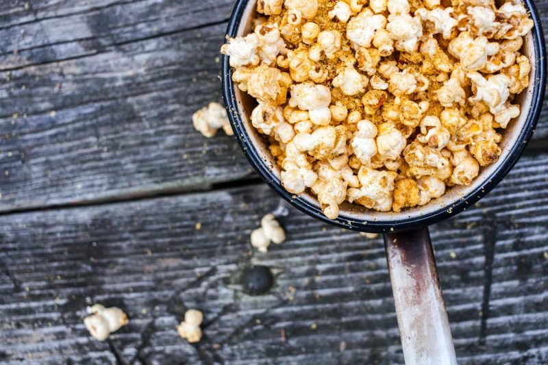 Freshly popped Smokey Spiced Paprika Popcorn in a pot on a table.