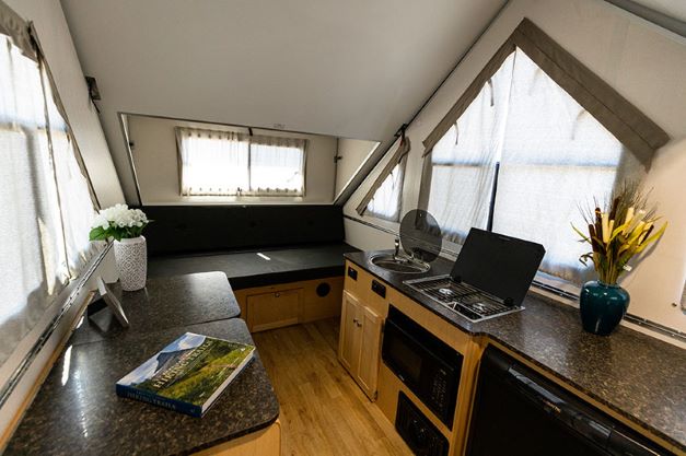 Interior of new Aliner Expedition popup camper has multiple windows that let in plenty of natural light