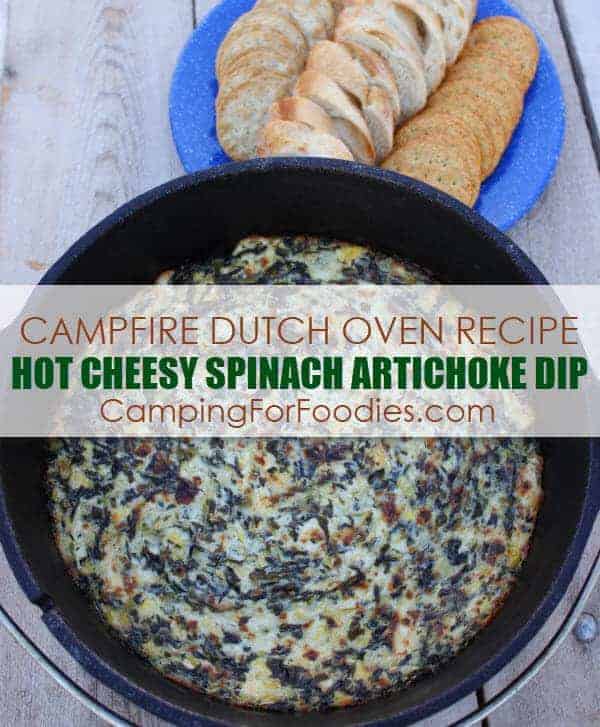 Hot Cheesy Spinach Artichoke Dip ready to eat in a Dutch oven with crackers and bread near it.