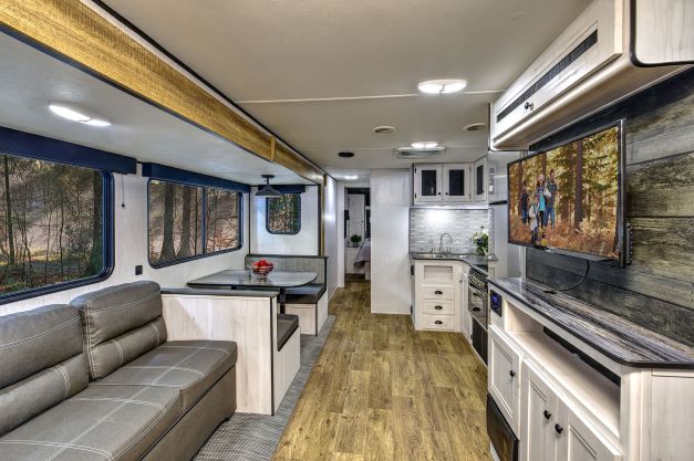 Kitchen island and sofa seating inside the new Heartland Trail Runner travel trailer