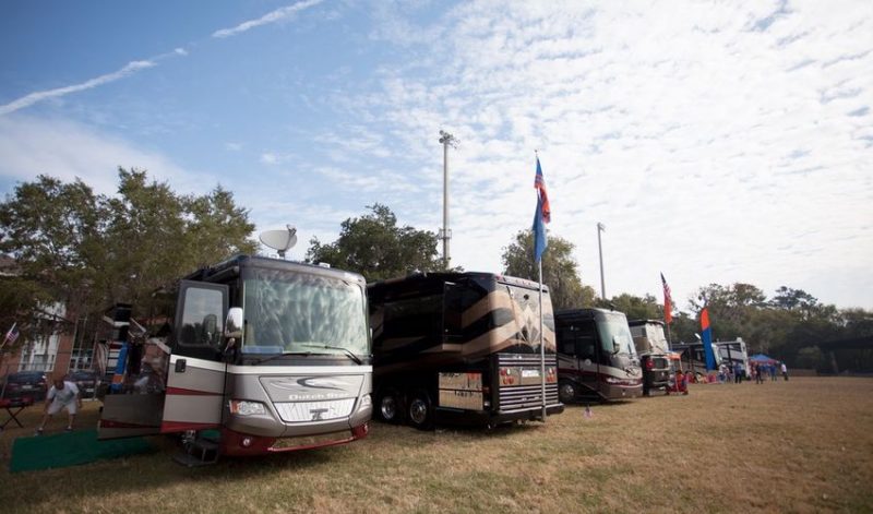 A group of RVs parked for the tailgating party.